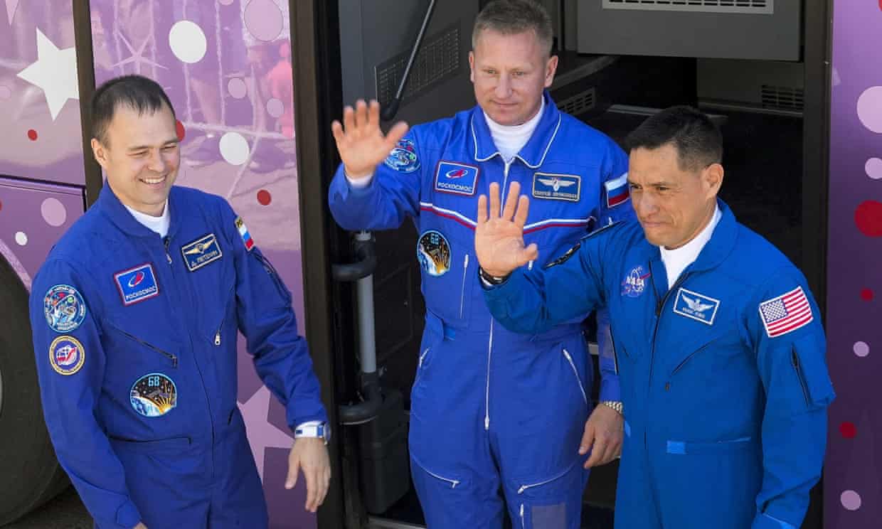 US astronaut Frank Rubio (right) with Russian cosmonauts Sergey Prokopyev (centre) and Dmitri Petelin wave to  relatives and friends before the launch of the Soyuz-2.1 rocket  in Kazakhstan