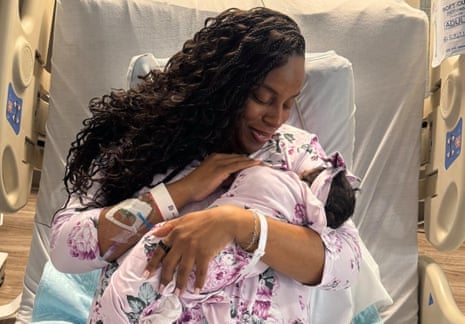 LaMonica McIver smiles in a hospital bed while cradling her newborn baby