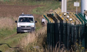Police patrol the perimeter of the army barracks in Flawinne, Belgium.