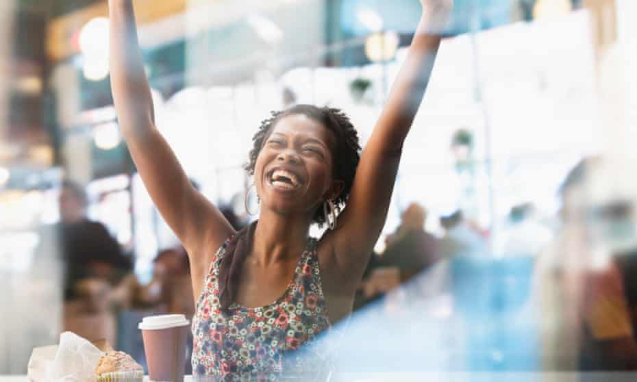 Woman cheering in a cafe