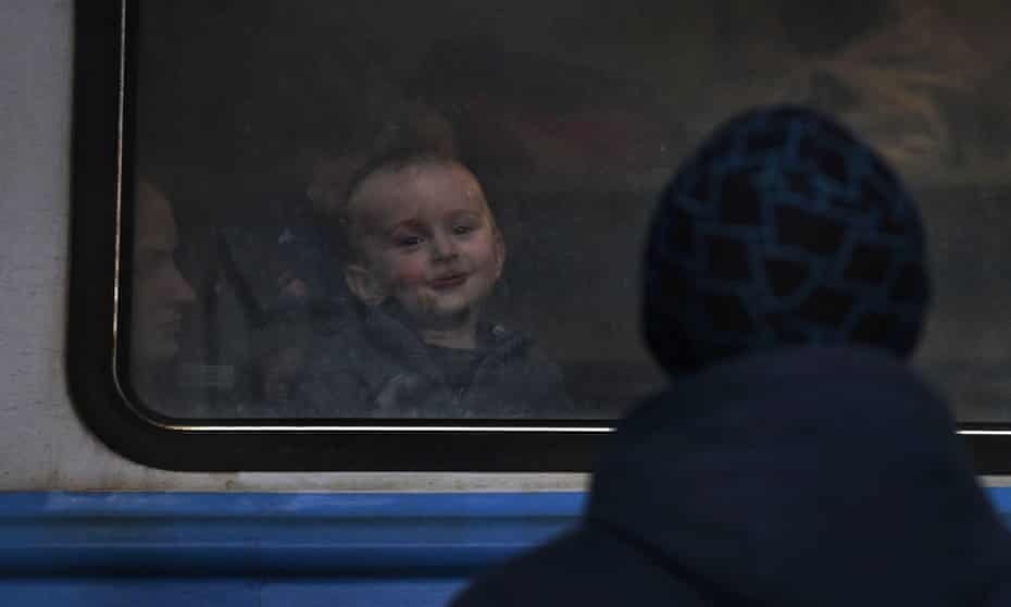 People fleeing the Russian invasion board a train for Poland at the central station in Lviv, Ukraine.