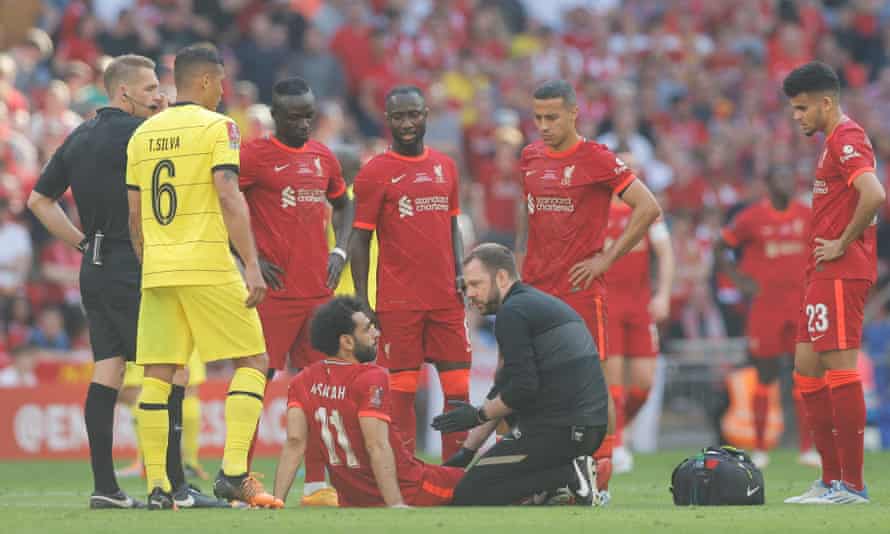 Mohamed Salah of Liverpool receives treatment before being forced off with a groin injury.