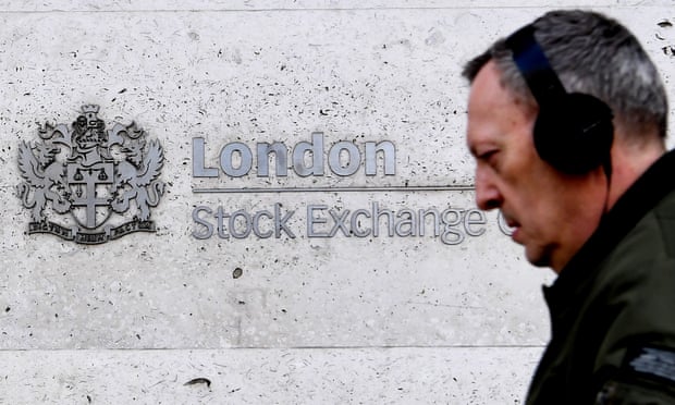 A pedestrian passes the London Stock Exchange