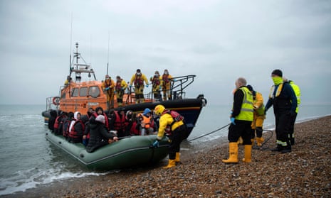 Migrants being helped ashore from a lifeboat in Dungeness, Kent, 24 November 2022.