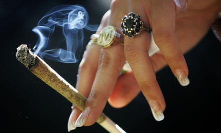 A woman holds a joint