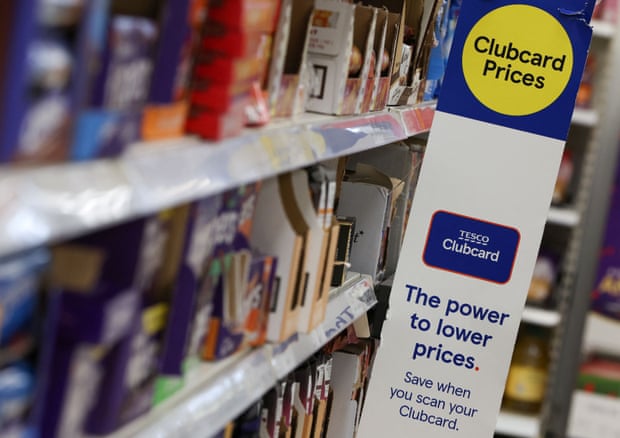 Clubcard branding is seen inside a branch of a Tesco Extra supermarket in London