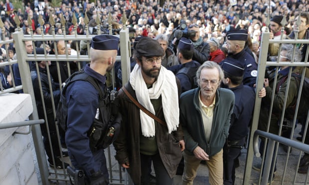Cédric Herrou, centre, arrives at the court in Nice, southern France.