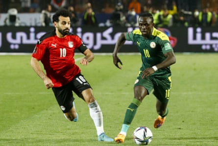 Egypt’s Mohamed Salah (left) vies for the ball with Sadio Mane during a 2022 World Cup qualifier in Cairo