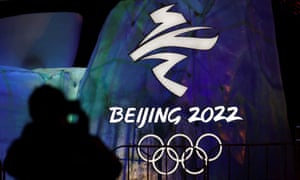 A man photographs an illuminated logo ahead of the Beijing 2022 Winter Olympics in Beijing, China.