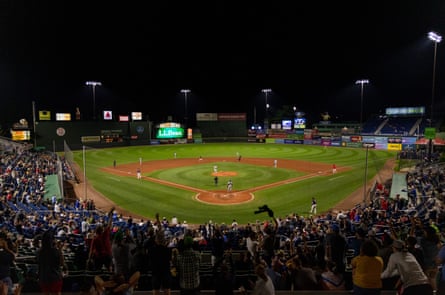 Behind home plate view as Portland Sea Dogs Christian Koss hits a home run in the sixth inning of Portlands second game of a double header against the Hartford Yard Goats on August 27, 2022, causing the crowd to erupt into cheers at Hadlock Field.