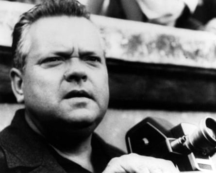 Black and white image of Orson Welles holding a camera