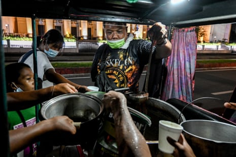 A church volunteer distributes chocolate porridge for dinner. Donations became scarce as the lockdown dragged on.