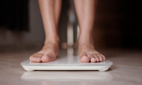 Woman on scales measuring weight