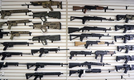 Semi-automatic rifles fill a wall at a gun shop in Lynnwood, Washington, in 2018. As of 1 January, no one under the age of 21 in Washington can purchase a such weapons.
