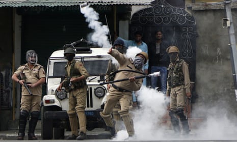An policeman throws a tear gas shell at Kashmiri protesters demonstrating against Indian rule in Srinagar.Kashmir on Friday.