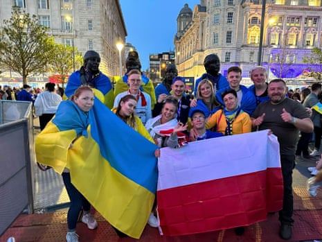 Some of the visiting aid workers by the Beatles statue in Liverpool.