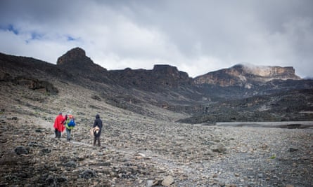 Three walkers on a quiet section of Kilimanjaro, trail on the remote Northern Circuit