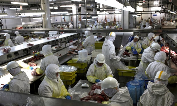 Workers process meat at the Minerva SA processing plant in Barretos, Brazil