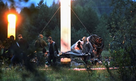 Emergency services remove a body bag from the scene of the crash