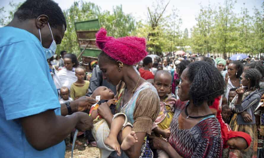An aid worker screens a child for malnutrition in Adikeh, in the Wajirat district of the Tigray region of northern Ethiopia on 19 July, 2021.