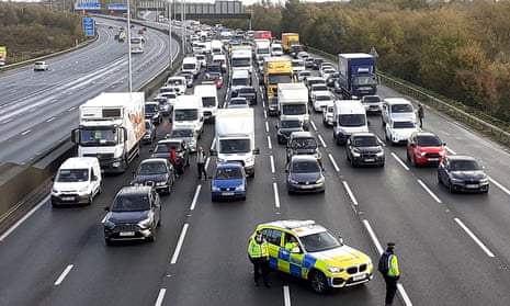Police closing the M25 during a Just Stop Oil protest.