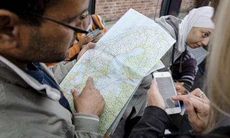 A man checks a map of Sweden after arriving in the country