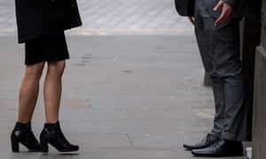 A woman and a man talk in a street