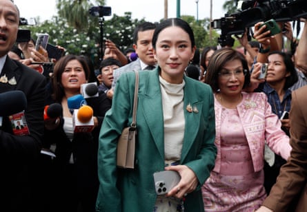 Thai prime minister Paetongtarn Shinawatra (C) is surrounded by journalists after a cabinet meeting at Government House in Bangkok, Thailand, on Tuesday.