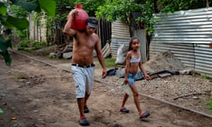 Victor Funes and his daughter Patricia carrying water in Nejapa, El Salvador