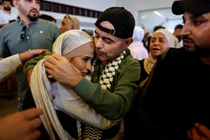 Woman and man hugging amid a crowd of people