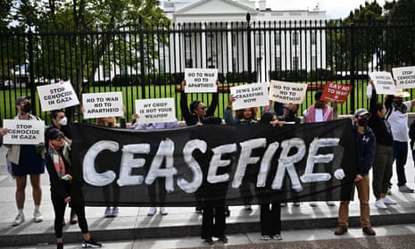 protesters carrying sign reading 'ceasefire' outside the white house
