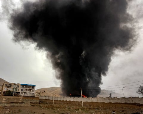 Black smoke and flames rising from a structure.