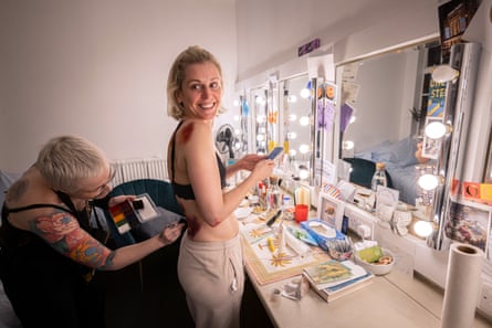 Denise Gough has bruising make-up applied to her back in her dressing rooms for People, Places & Things at Trafalgar Studios.