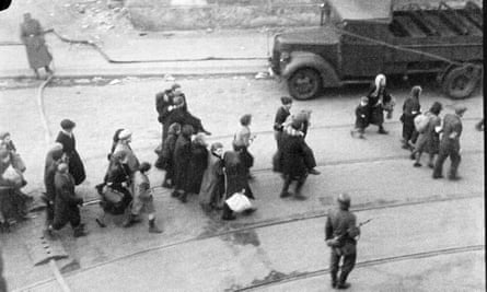 Jewish people being led away in the Warsaw ghetto.
