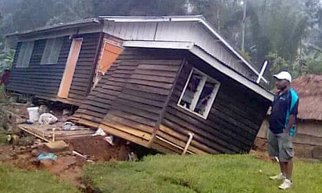 A local stands next to a damaged house near a landslide in the town of Tari after an earthquake struck Papua New Guinea’s Southern Highlands