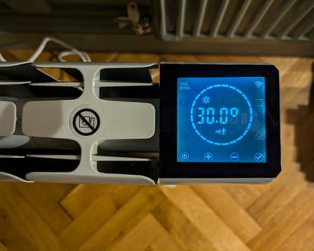 The digital display panel of an electric heater showing the temperature