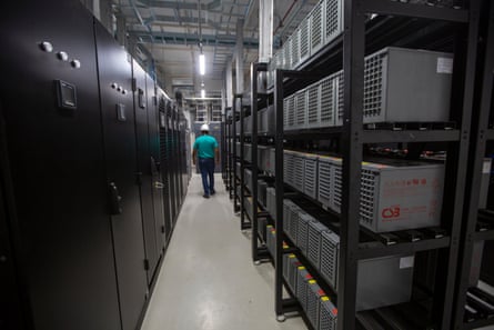 A man walks between machines in a datacentre