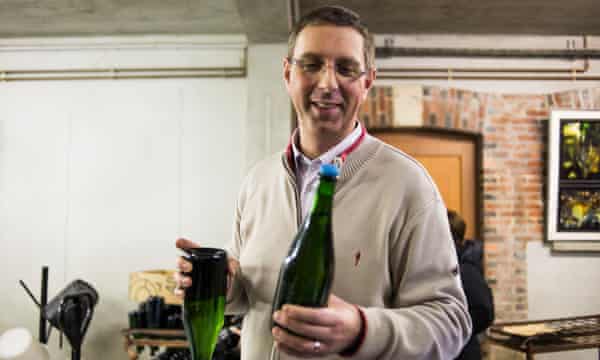 man holding champagne bottles