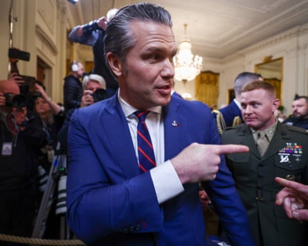 Man in blue suit points