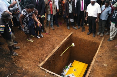 Mourners gather around the grave of Joe Leahy at Kilima plantation