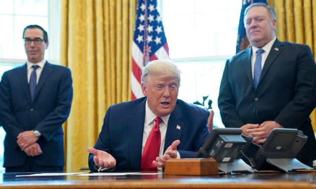 President Donald Trump in the Oval Office flanked by the treasury secretary, Steven Mnuchin, left, and secretary of state, Mike Pompeo.