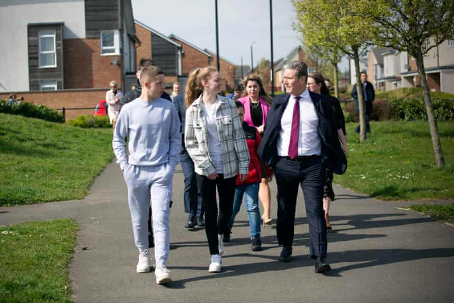 Keir Starmer taking a walk with local teenagers during a visit today to the SARA Project based at the Salvation Army centre in Sunderland.