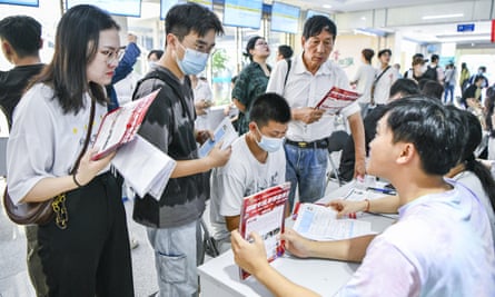 Graduates look for work at a jobs fair in Haikou, Hainan province.