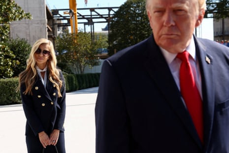 Katie Zacharia stands behind Donald Trump