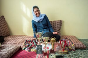 Nazira Khairzad aged 18, poses for a picture at her home with her trophies and medals from other sporting events including skiing, football and marathons.