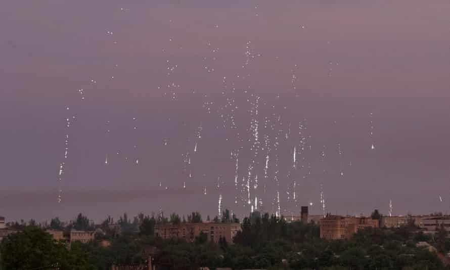Incendiary ammunition airbursts are seen during a shelling, as Russia’s attack on Ukraine continues, in the town of Marinka in the Donetsk region