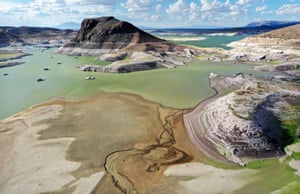 New Mexico, US. A recently exposed lakebed, with boats anchored near a bathtub ring of mineral deposits left by higher water levels, at the drought-stricken Elephant Butte reservoir