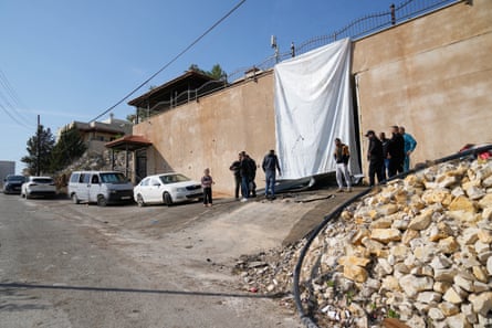 People at the site of the garage in Jenin where the two Palestinian men were shot by Israeli forces on Thursday.
