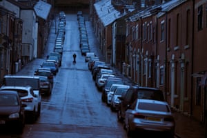 30 April – A man crossing the road during rain showers in Blackburn