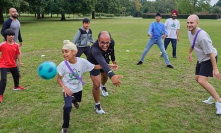 Children and parents play together at ParkPlay in Southall, London.
